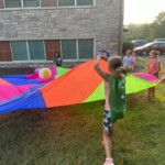 Playing hero parachute games during Hero Central Vacation Bible School at Peace Tohickon Lutheran Church